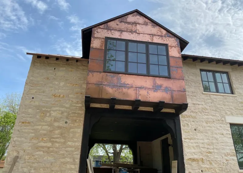 Copper metal panel facade on a stone building for Metal Roof Coating in Wyoming